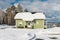 Green houses in snow forest.