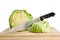 Green iceberg lettuce with knife on wooden choppin