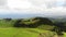 Green idyllic farm fields. Aerial forward. Sao Miguel Island, Azores