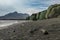 Green ignimbrite rock formations on the beach in southern iceland. Volcanic conglomerate with boulders and cobbles around