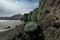 Green ignimbrite rock formations on the beach in southern iceland. Volcanic conglomerate with boulders and cobbles around