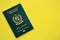 Green Islamic Republic of Pakistan passport on yellow background close up