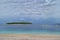 A green island in the azure sea. Beach, boats and cloudy sky. Primosten, Croatia,