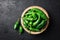 Green jalapeno hot pepper in wooden plate