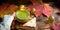 Green Japanese matcha tea with foam in transparent Cup on wooden table in autumn still life. Women`s hand with long white sweater