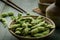 Green Japanese Soybean in wooden bowl on table wood