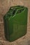 Green jerry can on wooden surface