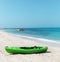 Green kayak on the beach