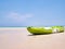 Green Kayak boat on the tropical beach background and clear blue sky at sea. Happy summer holiday concept