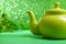 Green kettle on abstract background