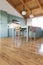 Green kitchen interior in bokeh with an emphasis on wooden floors.