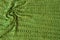 Green knit background with twisted folds