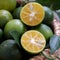 Green Kumquat fruit on wooden background