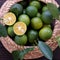 Green Kumquat fruit on wooden background