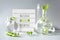 Green laboratory. Text Natural Green Aesthetics on white pallet. Exotic green leaves in transparent glass flasks, vials