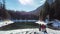 Green Lake - A drone shot of a couple sitting at the bench at the shore of Green Lake