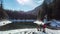 Green Lake - A drone shot of a couple sitting at the bench at the shore of Green Lake