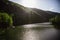 The Green Lake of Hamori in Lillafure near Miskolc, Hungary. Spring landscape with sunrays covering the mountains. The solar path