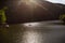 The Green Lake of Hamori in Lillafure near Miskolc, Hungary. Spring landscape with sunrays covering the mountains. The solar path