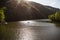 The Green Lake of Hamori in Lillafure near Miskolc, Hungary. Spring landscape with sunrays covering the mountains. The solar path