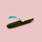 Green large cucumber with a razor blade on a pastel pink background. The concept of depilation care. Abstract poster