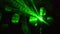 Green laser light glowing in the dark in the night club