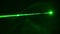 Green Laser Ray in Smoke Close-Up on a Black Background