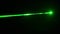 Green Laser Ray in Smoke Close-Up on a Black Background