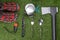 On the green lawn, laid out items for the traveler, comfortable shoes, spoon, fork, knife, flashlight, gas burner and hatchet