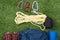 green lawn lie items for mountaineering, a bunch of ropes, a set of carbines, a backpack and shoes