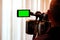 Green LCD display on high definition television camera. Videographer at work removes the story for the news. Template template for