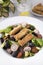 Green leafy salad, tomato, avocado, radishes, olives and tofu fingers. Vegetarian salad