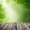 Green Leaves, Bokeh Light and Empty Wooden Table