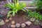 Green leaves flower on the front home with stone on the side