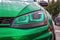 Green led headlights with lens on green modified tuned car. Custom car