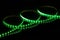 Green LED strip tape on black background