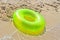 Green life buoy on beach