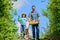 Green life. farmer man with little girl. garden tools, shovel and watering can. kid worker with dad hold box. family