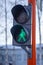 Green light on a pedestrian traffic light. Safe crossing of the road