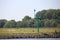 Green light pole for waterway marking at Alblasserdam on riverside of river Noord.