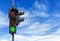 Green light semaphore with cloudy sky background