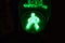 Green light of traffic light on the pedestrian crossing in the form of a human silhouette. Road crossing permit, signal to go for