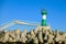 Green lighthouse with star-shaped stones in the black sea seaport