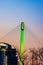 Green lighting of tower and cables of Bob Kerrey foot bridge with backdrop of River Front Condominiums Omaha Nebraska