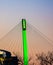 Green lighting of tower and cables of Bob Kerrey foot bridge with backdrop of River Front Condominiums Omaha Nebraska