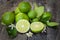 Green lime lemon on wood