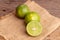 green lime and seed place on woven sack on the wooden table in a kitchen