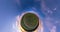 Green little planet revolves among evening dark blue sky. Little planet transformation with curvature of space. loop rotate