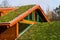 Green living roof on wooden building covered with vegetation