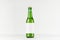 Green longneck beer bottle 330ml with blank white label on white wooden board, mock up.